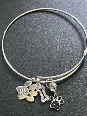 925 sterling silver expandable bangle with dog bone + paw charms.